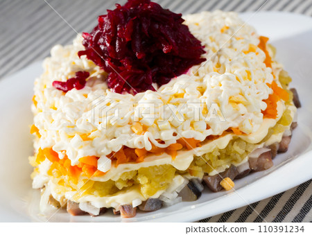Photography of plate with Dressed herring is russian traditional dish 110391234