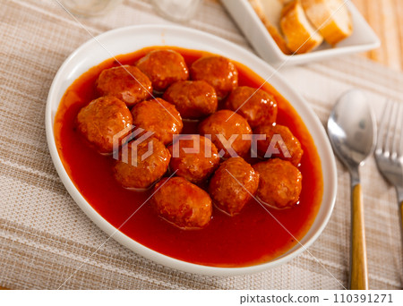 Appetizing meatballs with tomato sauce served on platter Appetizing meatballs with tomato sauce served on platter 110391271