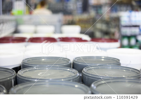 Cans buckets of paint are on shelf, shop window Cans buckets of paint are on shelf, shop window 110391429