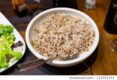 Popular dish of Oriental cuisine is rice with lentils 110391543