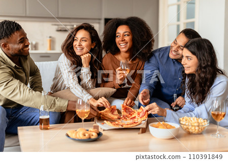 Diverse friends gathering for home dinner with beer and pizza 110391849