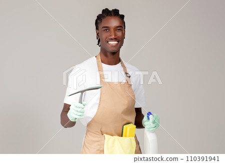Cleaning Services. Handsome Black Cleaner Man Posing With Detergents And Washing Tools 110391941
