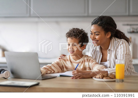 Online Education. Black Mom And Her Preteen Son Using Laptop At Home, 110391991