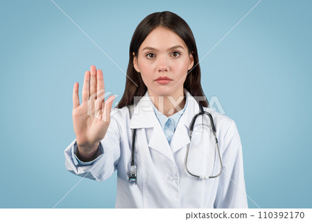 Doctor woman gesturing stop with a serious expression Doctor woman gesturing stop with a serious expression 110392170