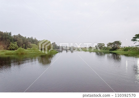 River view with lush green river banks River view with lush green river banks 110392570