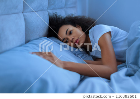 Depressed African Woman Touching Empty Pillow In Bed At Night 110392601