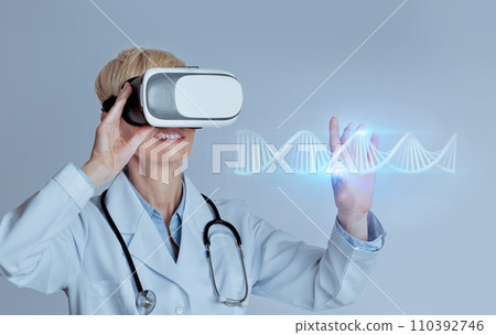 Professional woman doctor in VR glasses studying blue glowing virtual human DNA strand, using futuristic CRISPR method 110392746