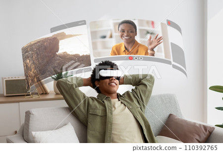 Virtual reality bridges gap as young black guy in VR glasses enjoys lifelike video chats from the comfort of his home Virtual reality bridges gap as young black guy in VR glasses enjoys lifelike video chats from the comfort of his home 110392765