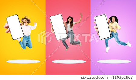 New App. Happy Multiethnic Females Demonstrating Smartphone With Big Blank Screen 110392968
