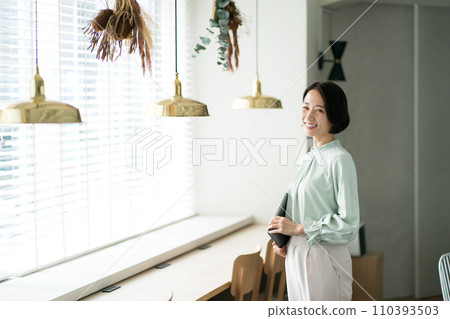 Female standing with a tablet Female standing with a tablet 110393503