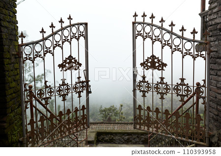 A metal gate opens up into the clouds at the Pura Pasar Agung Sebudi temple on the mountain after an ash eruption at Mount Agung on the popular tourist island of Bali 110393958