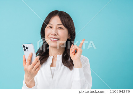 A middle-aged woman who operates a smartphone. A middle-aged woman who operates a smartphone. 110394279