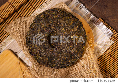 Chinese Puerh tea in the package. the Chinese dry the tea. the view from the top. Shen PUerh, Shu puer. Chinese Puerh tea in the package. the Chinese dry the tea. the view from the top. Shen PUerh, Shu puer. 110394586