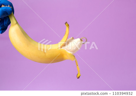 Intimate piercing. Minimal piercing concept. Banana with inserted iron decoration, piercing 110394932