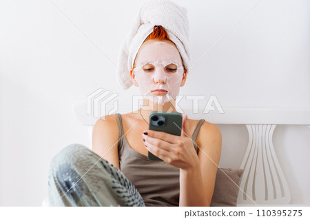 Skin care beauty cosmetic mask young redhead woman 110395275