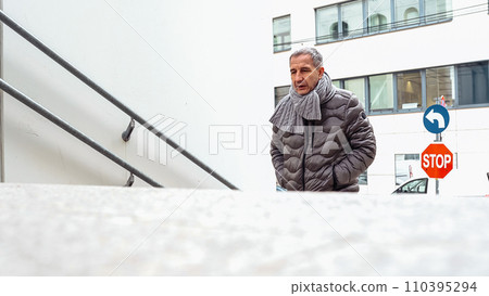 Man walking up stairs Man walking up stairs 110395294