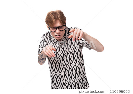 European young man with golden hair and a tattoo on his arms, dressed in a summer black and white European young man with golden hair and a tattoo on his arms, dressed in a summer black and white 110396063