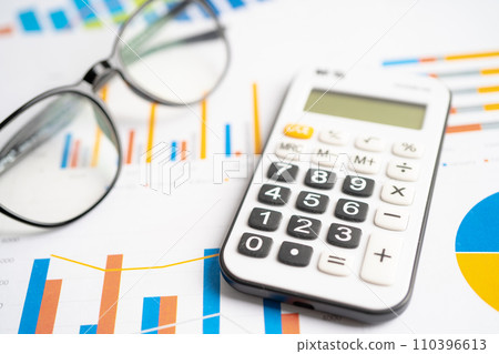 Eyeglass with calculator on chart graph paper. Finance, account, statistic, investment data economy, stock exchange business. Eyeglass with calculator on chart graph paper. Finance, account, statistic, investment data economy, stock exchange business. 110396613