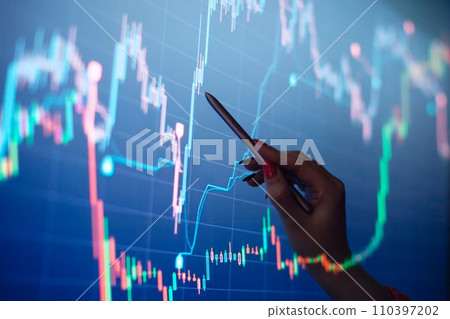 Businesswoman manually drawing a diagram on a touch screen interface. Stock market concept Businesswoman manually drawing a diagram on a touch screen interface. Stock market concept 110397202