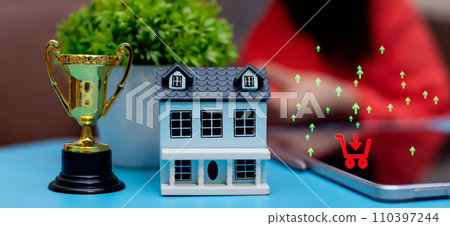 House model, trophy and smartphone. Real estate investment and home loan concept. House model, trophy and smartphone. Real estate investment and home loan concept. 110397244