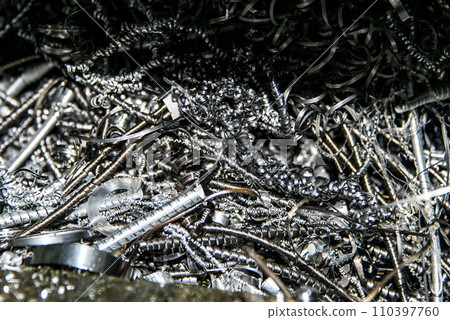 Scrap Closeup twisted spiral steel shavings twisted metal from lathe machine In industrial plants 110397760