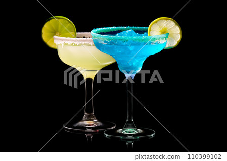 Set of Blue Curacao cocktails garnished with a lime isolated on black background Set of Blue Curacao cocktails garnished with a lime isolated on black background 110399102