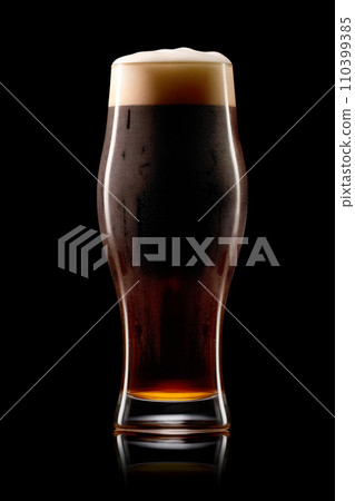 Beer in a tall glass on a dark black background. Mugs with drink like Ipa, Pale Ale, Pilsner, Porter or Stout Beer in a tall glass on a dark black background. Mugs with drink like Ipa, Pale Ale, Pilsner, Porter or Stout 110399385