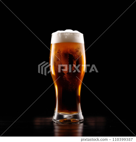 Beer in a tall glass on a dark black background. Mugs with drink like Ipa, Pale Ale, Pilsner, Porter or Stout Beer in a tall glass on a dark black background. Mugs with drink like Ipa, Pale Ale, Pilsner, Porter or Stout 110399387