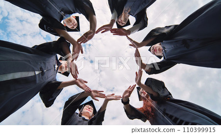 College graduates make a circle of their hands. College graduates make a circle of their hands. 110399915