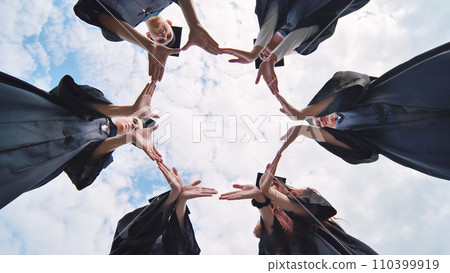 College graduates make a circle of their hands. College graduates make a circle of their hands. 110399919