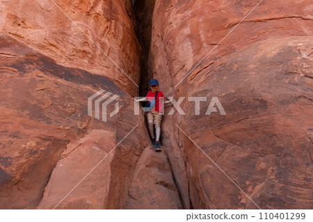 Boy Climbing Rocks in Arches National Park, Utah Boy Climbing Rocks in Arches National Park, Utah 110401299