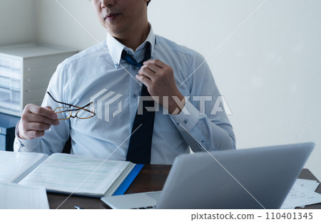 Hand of a tired businessman loosening his tie 110401345