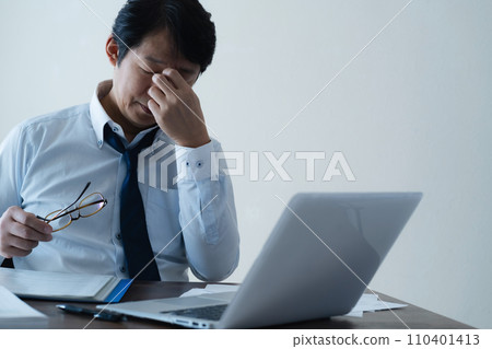 Businessman tired from working long hours 110401413