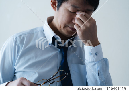 Businessman tired from working long hours Businessman tired from working long hours 110401419