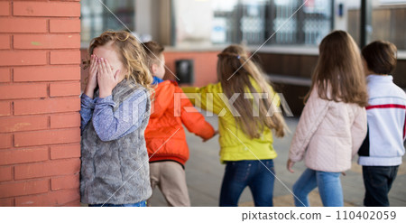 Children playing hide and seek in the schoolyard Children playing hide and seek in the schoolyard 110402059