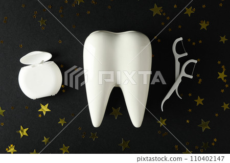 Teeth with festive stars, on a dark background. Teeth with festive stars, on a dark background. 110402147