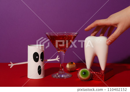 Big tooth with Halloween accessories, on a colored background. Big tooth with Halloween accessories, on a colored background. 110402152