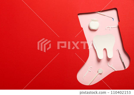 Teeth with Christmas accessories around, flat lay. Teeth with Christmas accessories around, flat lay. 110402153