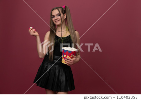 Portrait of impressed lady hand hold popcorn isolated on red color background Portrait of impressed lady hand hold popcorn isolated on red color background 110402355