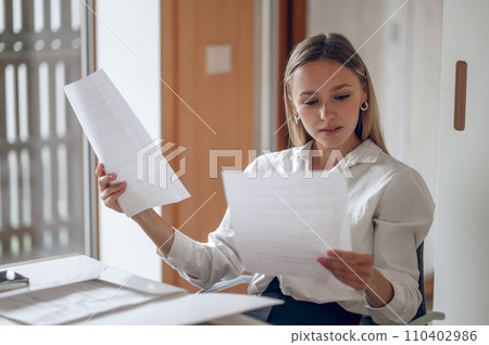 Young business woman looking serious and concentrated Young business woman looking serious and concentrated 110402986