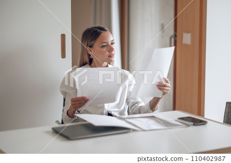 Cute blonde young wo,an working with documents 110402987