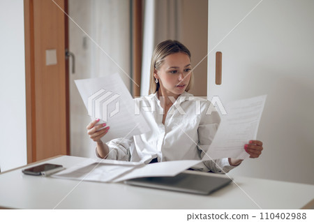 Cute blonde young wo,an working with documents 110402988
