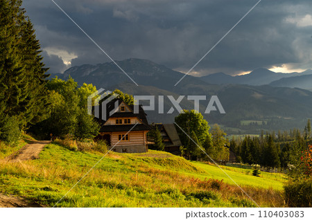 Beautiful country view with mountains in the background. View of the Tatra Mountains and Koscielisko Village in Poland. 110403083