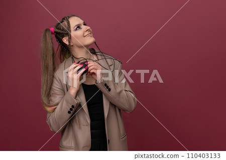 Beautiful young woman with lots of computer cables over her head, peeking behind a computer mouse 110403133