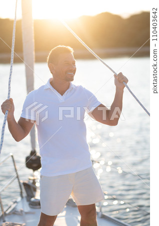 Well-built man in white tshirt on the yacht 110403642