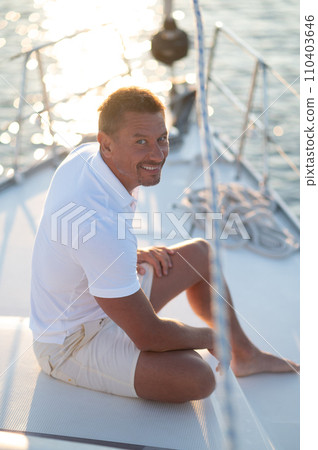 Well-built man in white tshirt on the yacht 110403646