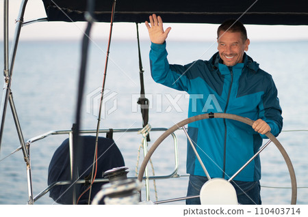 Smiling mature man sailing a ship 110403714