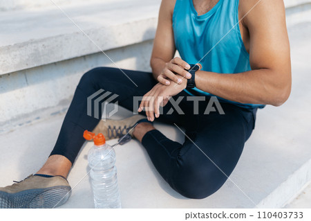 Close up picture of a sportsman resting after workout 110403733
