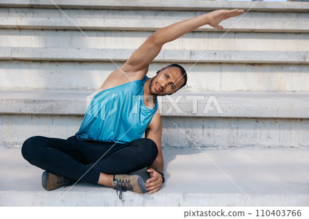 Man on the stairs doing stretching Man on the stairs doing stretching 110403766