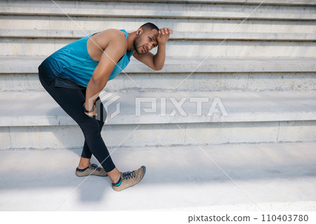 Man on the stairs doing stretching Man on the stairs doing stretching 110403780